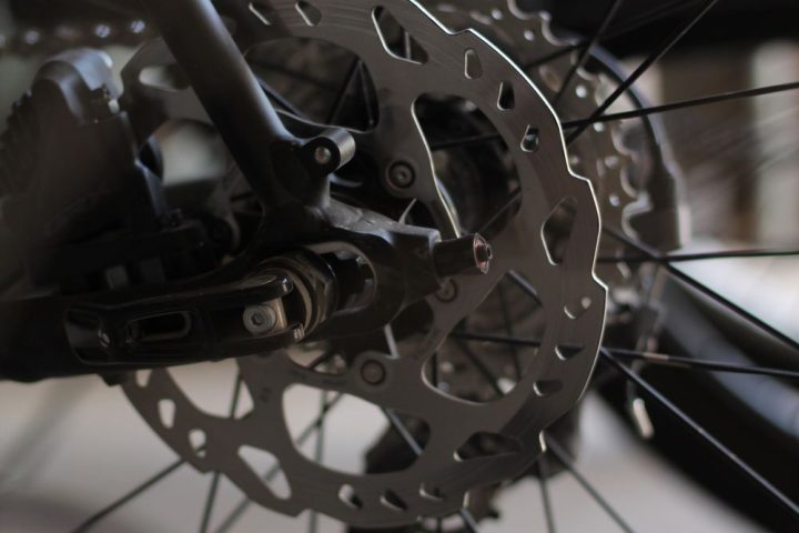 Close-up of a bicycle wheel, brake and spokes